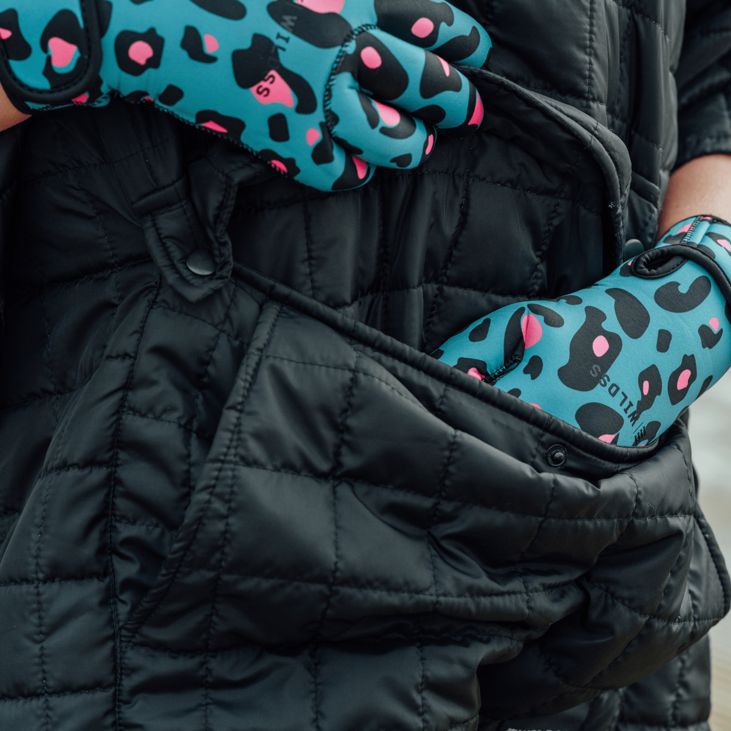 Image of woman wearing weatherproof black robe with large front pocket