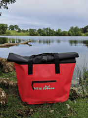 product shot of a coral coloured Wild Moose tote bag on the shores of a Lakeland tarn